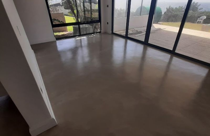 Micro screed flooring in modern living room with glass doors